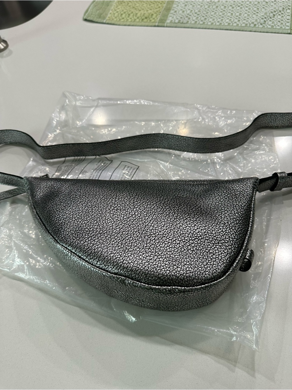 The Sak mini sling crossbody handbag in silver leather - never used